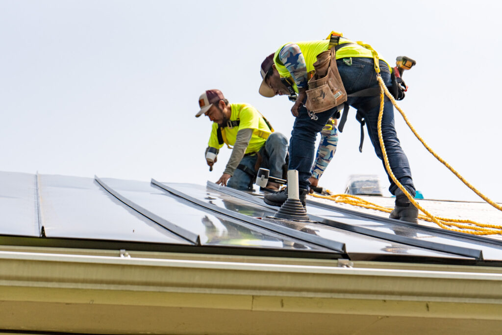 roofers completing a roof replacement